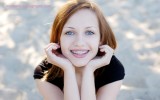 Pretty girl wearing braces smiling cheerfully